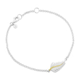 A sterling silver bracelet with a delicate feather charm and a yellow gold vermeil center stem, displayed on a white background.